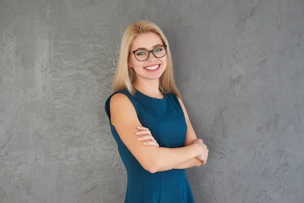 Happy businesswoman with arms crossed — Stock Photo, Image