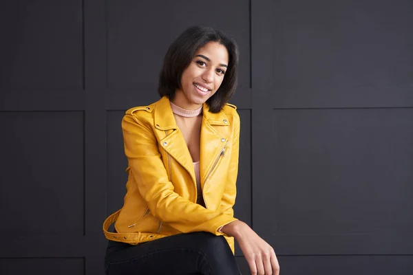 Teenage girl smiling in yellow leather jacket — Stock Photo, Image