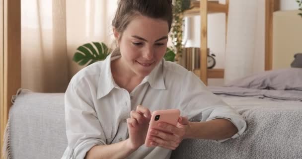 Vrouw die thuis mobiele telefoon gebruikt — Stockvideo