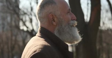 Parkta yürüyen yakışıklı adam.