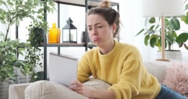 Not defterine yazan düşünceli kadın.