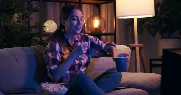 Женщина развлекается, смотря телевизор ночью — стоковое видео