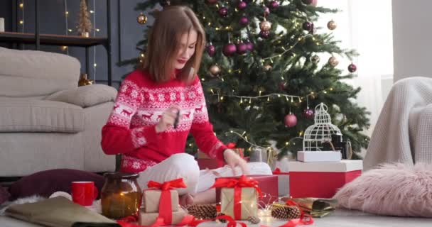 Mulher embalagem presente de Natal em casa — Vídeo de Stock
