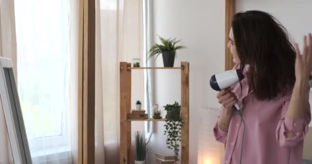 Mujer secándose el pelo delante del espejo — Vídeos de Stock