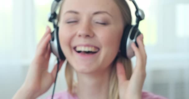 Mujer escuchando música usando auriculares — Vídeos de Stock