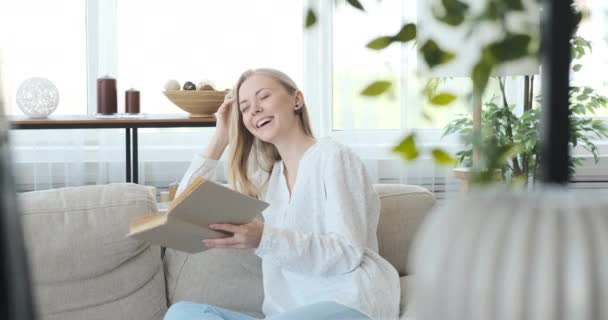 Femme lisant un livre dans le salon — Video