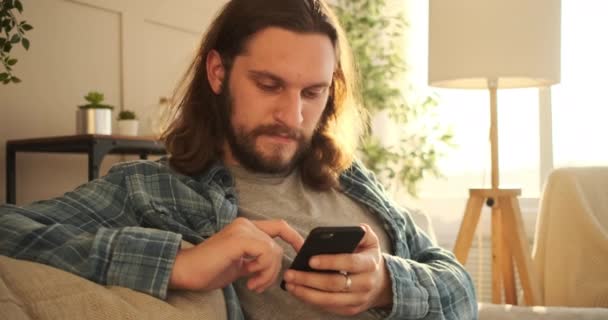 Mann benutzt Handy zu Hause — Stockvideo