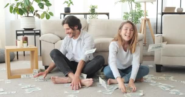 Сумасшедшая пара бросает деньги в воздух — стоковое видео