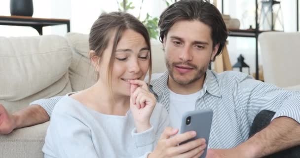 Couple using mobile phone at home — Stock Video