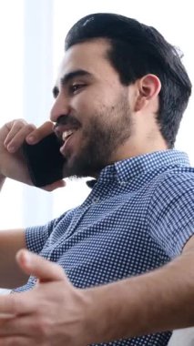 Yetişkin bir adam evdeki kanepeye yaslanır, gözleri kapalı ve gülümserken kulaklıkla kulaklıkla müzik dinler, yavaş çekimde yakalanır..