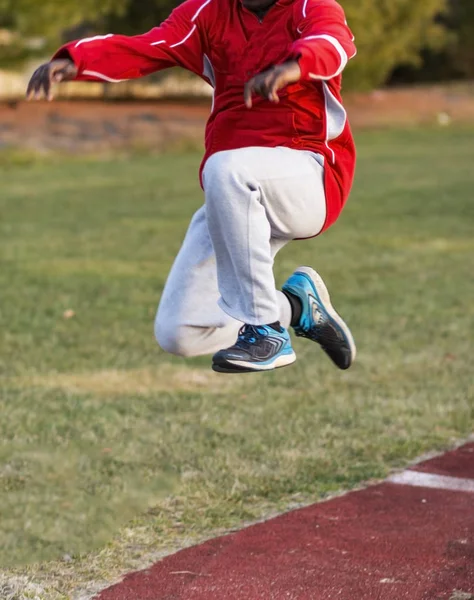 Triple jumper during third stage of jump at practice — Stock Photo, Image
