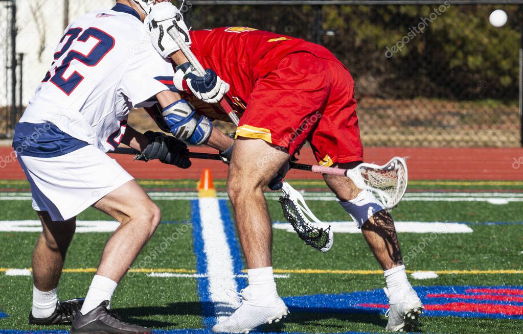 Lacrosse faceoff with stick hiiting crotch of opponent