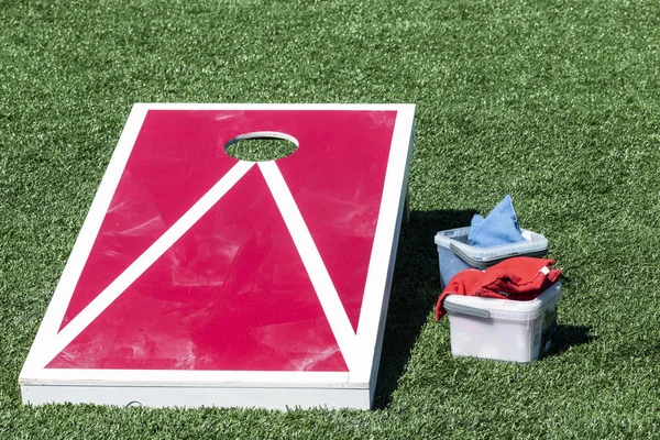 Close up of red and white corn hole game with bean bags