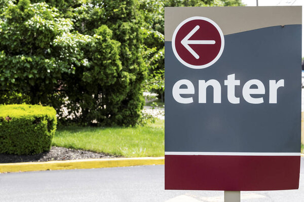 Maroon and gray enter sign with an arrow pointing left