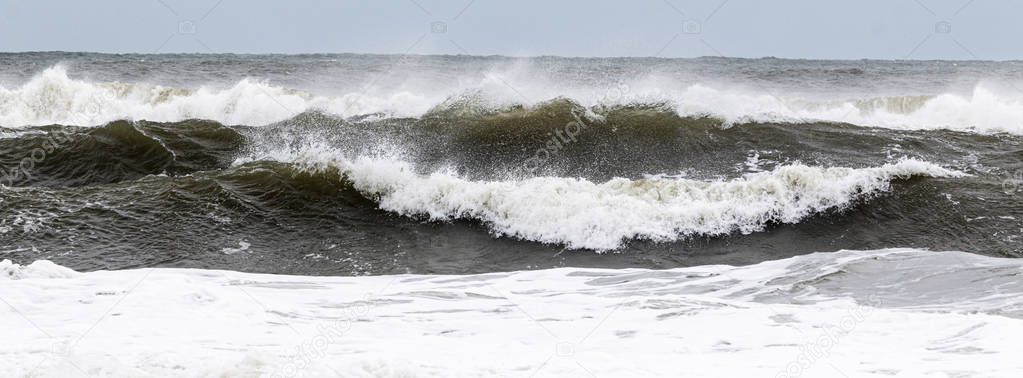 Rough ocean waves from tropical storm with heavy winds blowing t