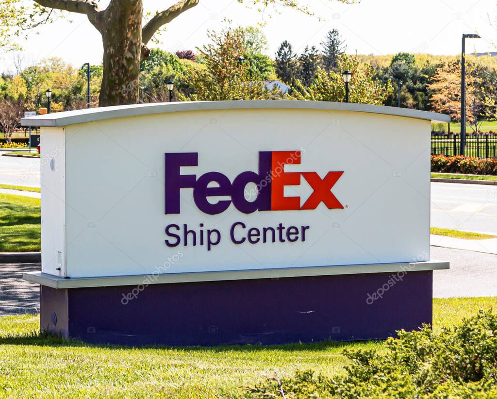 Melville, New York, USA - 13 May 2020: FedEx Ship Center sign on the side of the road in Melville Long Island.