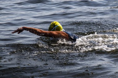 Sporcu açık denizde yüzme, serbest stil tekniği ve hızda yarışır..