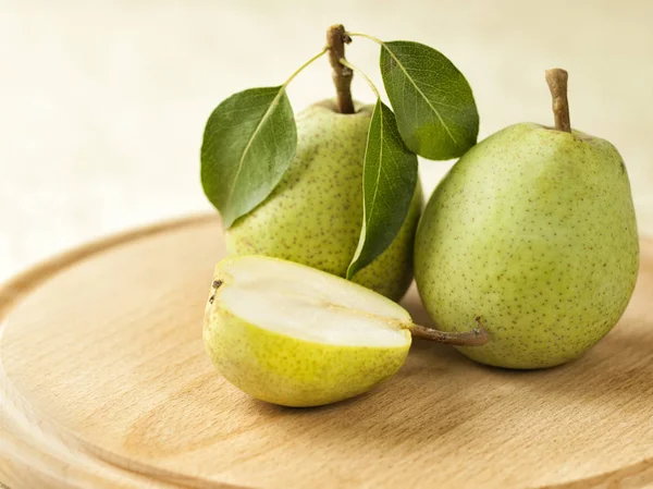 Three pears are lying on the table