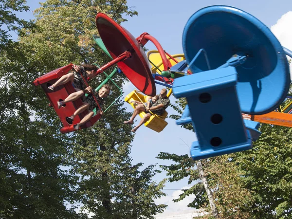 Vinnitsa, Ukraine. 08. 24. 2019. People ride fun on large multi-colored carousels — Stock Photo, Image