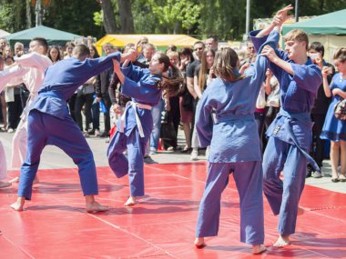 Vinnitsa, Ukrayna - 22 Mayıs 2018: Kimonolu erkek ve kızlar sokaktaki herkesi nefsi müdafaa priyom olarak gösteriyor