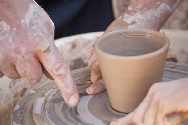 stock image A potter craftsman transfers his skills to a student