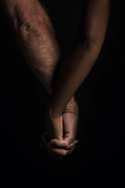 Çok ırklı bir çiftin el ele tutuşması.