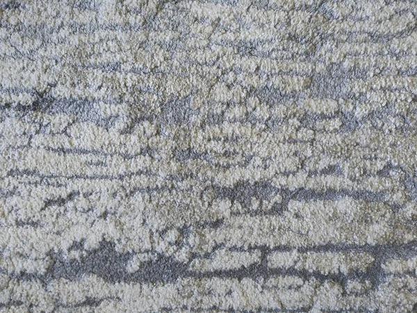 Stained pattern of a synthetic carpet