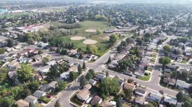 4K aerial view of Parkridge in Saskatoon, highlighting family homes, parks, schools, and residential streets in this westside community.