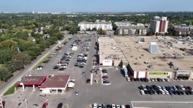 4K aerial view of Nutana Suburban Centre in Saskatoon, showing condos, retail, seniors housing, schools, and parks in this central east side neighborhood.