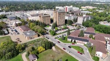 4K aerial view of Nutana Suburban Centre in Saskatoon, showing condos, retail, seniors housing, schools, and parks in this central east side neighborhood.