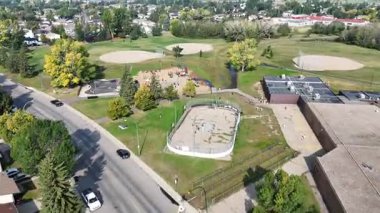 4K aerial view of Parkridge in Saskatoon, highlighting family homes, parks, schools, and residential streets in this westside community.