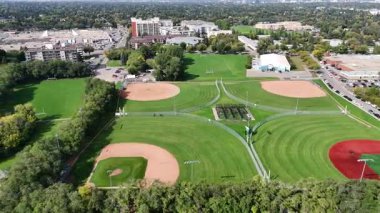 4K aerial view of Nutana Suburban Centre in Saskatoon, showing condos, retail, seniors housing, schools, and parks in this central east side neighborhood.