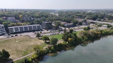 4K aerial view of Nutana in Saskatoon, looking over Rotary Park and the South Saskatchewan River with stunning city and riverside scenery.