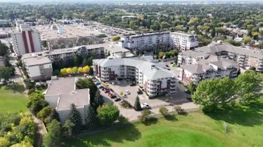 4K aerial view of Nutana Suburban Centre in Saskatoon, showing condos, retail, seniors housing, schools, and parks in this central east side neighborhood.