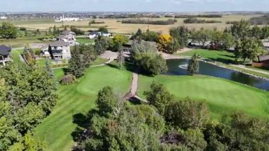 Aerial footage of Greenbryre in 4K, showcasing fairways, ponds, and elegant residences in this prestigious development.