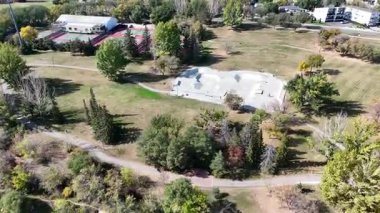 4K aerial view of King George in Saskatoon, showing homes, schools, parks, and its riverside location near the South Saskatchewan River.