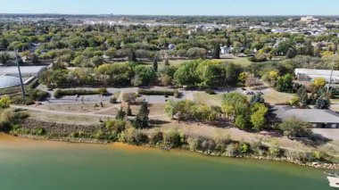 4K aerial view of King George in Saskatoon, showing homes, schools, parks, and its riverside location near the South Saskatchewan River.
