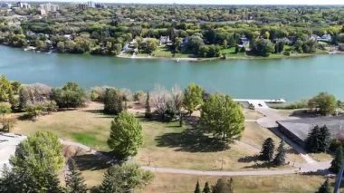 4K aerial view of King George in Saskatoon, showing homes, schools, parks, and its riverside location near the South Saskatchewan River.