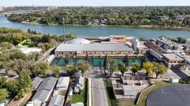 4K aerial view of King George in Saskatoon, showing homes, schools, parks, and its riverside location near the South Saskatchewan River.