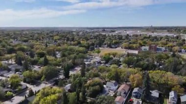 4K aerial view of King George in Saskatoon, showing homes, schools, parks, and its riverside location near the South Saskatchewan River.