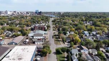 4K aerial view of King George in Saskatoon, showing homes, schools, parks, and its riverside location near the South Saskatchewan River.