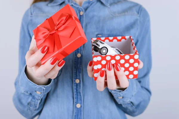 8 march valentine inside win winner lottery luck desire auto give idea girlfriend get give real people person happiness joke concept. Cropped close up view photo arms opening box with car isolated