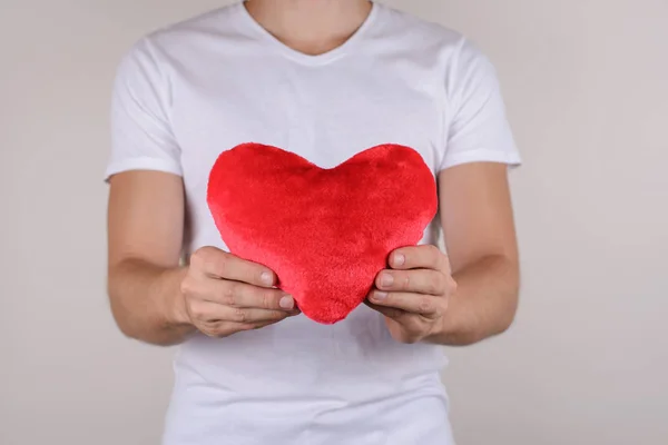 Passion life health healthy support help relief couple concept. Cropped close up photo studio portrait of handsome gentle macho gentleman holding big heart isolated grey background