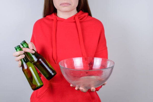 Cropped closeup photo of disappointed confused grimacing person holding showing empty plate isolated gray background