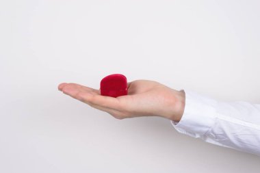 El Holding açık yan profil kırpılmış portre fotoğrafı açmak açmak kırmızı kalp ring içinde izole gri arka plan ile küçük küçük kutu şeklinde