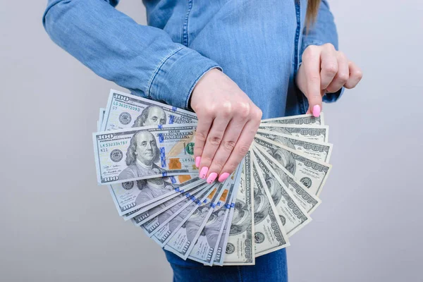 Closeup side profile cropped photo of she her lady closing covering intimate zone using holding pile of money wearing like skirt clothes isolated grey background