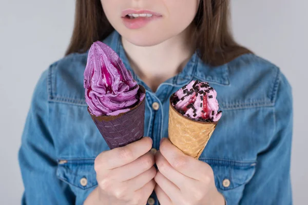Fast junk high calories food or health care concept. Cropped close up photo of unhappy doubtful hesitating thoughtful dream dreamy hipster lady making choice between two isolated grey background