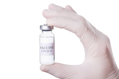 Coronavirus tedavisi konsepti. Doktorun elinde bir şişe COVID-19 su şeffaf aşısı olan beyaz arka planda izole edilmiş bir şişe tutarken çekilmiş makro kesilmiş fotoğrafı.