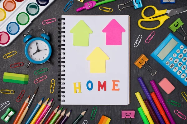 Studying at home concept. Top above overhead view photo of notebook and stationery isolated on blackboard