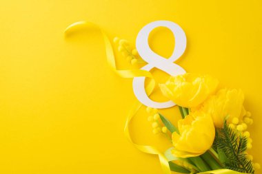 Parlak Kadınlar Günü motifi. Cömert lalelerin ve mimoza çiçeklerinin üst manzara fotoğrafı, sicimle korunmuş, ve güneşli sarı bir tuval üzerinde 8 tabela, yazım ve reklamlar için yer var.